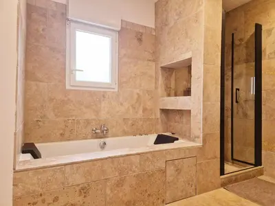 a large bathroom with a tub and a window at Chambres d hôtes, calme et nature in Pianottoli-Caldarello