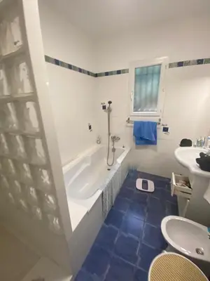 a bathroom with a tub and a toilet and a sink at u caseddu in Olivese
