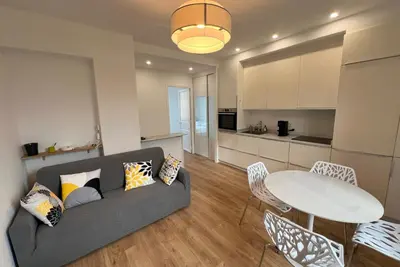a white bedroom with a bed and a mirror at Aurélie - Charming 1Br Trottel Beach - by TGB in Ajaccio