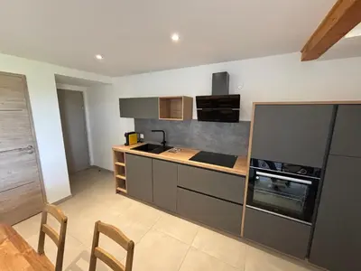 a kitchen with a counter and a stove top oven at LA MARANA - 1 minute des plages - Proche BASTIA AEROPORT - T2 entièrement neuf avec cuisine équipée in Lucciana