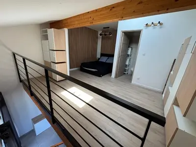 a room with a staircase leading to a bedroom at LA MARANA - 1 minute des plages - Proche BASTIA AEROPORT - T2 entièrement neuf avec cuisine équipée in Lucciana
