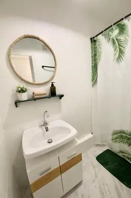 a white toilet in a bathroom with green shelves at Grand studio neuf, lumineux et au calme ! Tout équipé - Ajaccio in Ajaccio