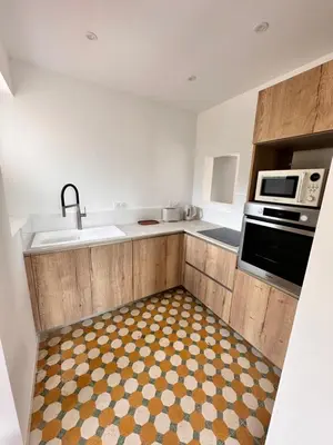 a kitchen with a sink and a microwave at Sposata - maison avec piscine privée - Figari in Figari