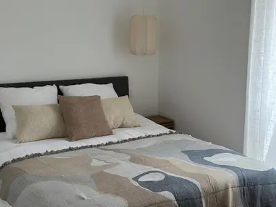 a bed with a blanket and pillows on it at Sposata - maison avec piscine privée - Figari in Figari