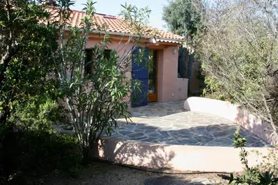 a house with a pathway leading to the front door at Villa Tarco in Porto-Vecchio