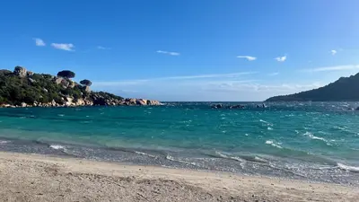 a beach with a group of people in the water at Villa Tarco in Porto-Vecchio