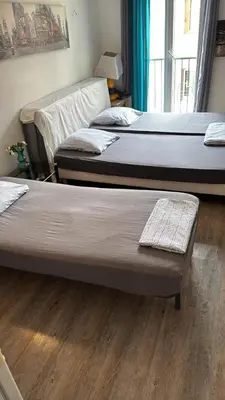 three beds in a room with wooden floors at Ajaccio CATHEDRALE in Ajaccio