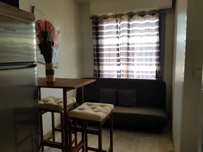 a living room with a couch and a table with stools at Ajaccio VUE MER IMPRENABLE 4a5 Pers in Ajaccio
