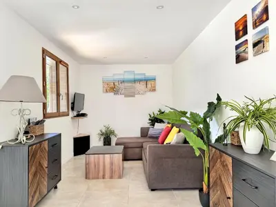 a living room with a couch and a tv at Bergerie A Mandria di Rondinara in Bonifacio