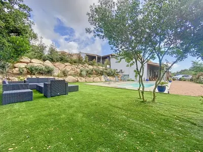 a yard with blue furniture and a swimming pool at Bergerie A Mandria di Rondinara in Bonifacio
