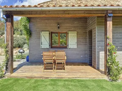 a wooden deck with chairs and a window at Bergerie A Mandria di Rondinara in Bonifacio