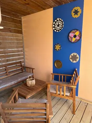 a room with two benches and clocks on the wall at Appartement dans résidence 3 étoiles in Lecci