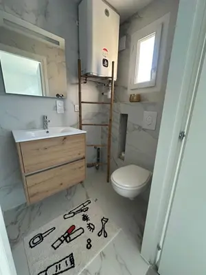 a bathroom with a sink and a toilet at Appartement dans résidence 3 étoiles in Lecci