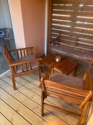 a room with two benches and a table at Appartement dans résidence 3 étoiles in Lecci