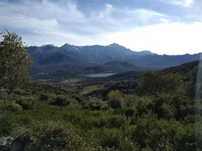 a view of a valley with mountains and a lake at Appartement à Speloncato dans la plaine du Reginu 2, pour 3 personnes in Speloncato