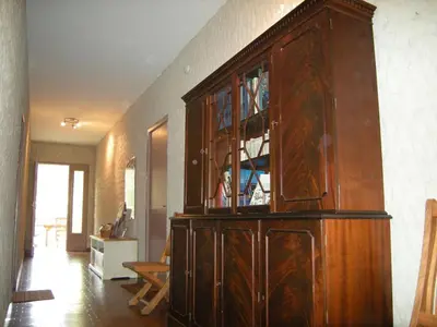 a large wooden cabinet in a living room at Appartement à Speloncato dans la plaine du Reginu 2, pour 3 personnes in Speloncato