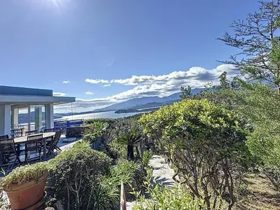 a house with a view of the ocean at Casa Blue Cala Rossa with Pool in Lecci
