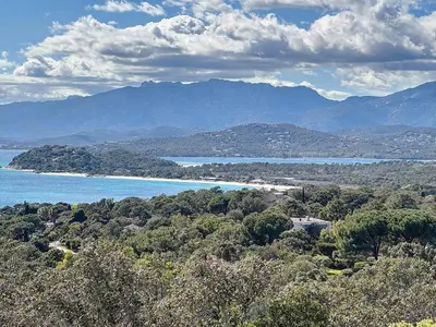 a view of a body of water with mountains at Casa Blue Cala Rossa with Pool in Lecci