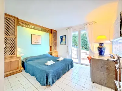 a bedroom with a blue bed and a window at Casa Blue Cala Rossa with Pool in Lecci