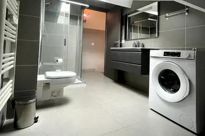 a bathroom with a washing machine and a sink at Apartment Propriano, Corsica in Propriano