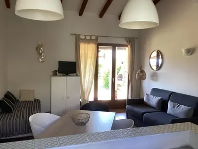 a living room with a couch and a table at Maison proche Porto Vecchio in Porto-Vecchio