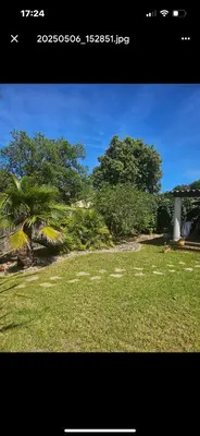 a walkway in a garden with flowers and bushes at Villa Marine de Solaro in Solaro
