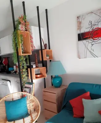a living room with a blue couch and a table at A casa in Propriano