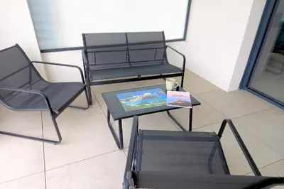 two chairs and a table with a picture on it at A casa in Propriano