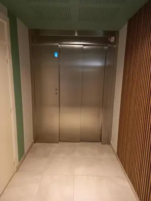 an elevator in a building with a metal door at A casa in Propriano