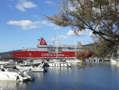 a large ship is docked in a marina with boats at A casa in Propriano