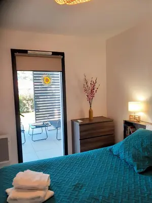 a bedroom with a bed and a door to a patio at A casa in Propriano
