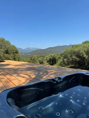 a bath tub sitting on top of a roof at Lodge sous les oliviers in Propriano