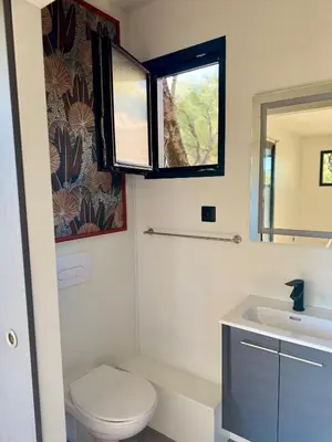 a bathroom with a toilet and a sink at Lodge sous les oliviers in Propriano