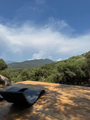 a bench sitting on top of a roof at Lodge sous les oliviers in Propriano