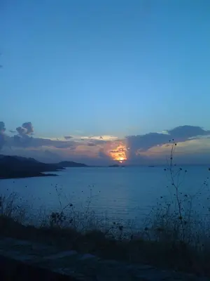 a sunset over a large body of water at Appartement à Speloncato dans la plaine du Reginu 1, pour 3 personnes in Speloncato