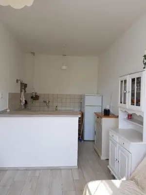 a kitchen with white cabinets and a counter top at Appartement à Speloncato dans la plaine du Reginu 1, pour 3 personnes in Speloncato