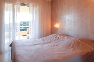 a white bed in a room with a window at NEPTUNE - Apartment 4 to 6 people - Port of Porto-Vecchio in Porto-Vecchio