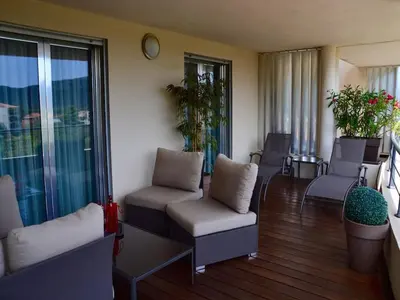a living room with chairs and a balcony at NEPTUNE - Apartment 4 to 6 people - Port of Porto-Vecchio in Porto-Vecchio