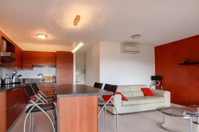 a kitchen and a living room with a couch at NEPTUNE - Apartment 4 to 6 people - Port of Porto-Vecchio in Porto-Vecchio