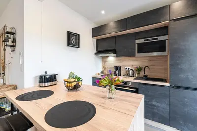 a kitchen with a wooden counter top in a room at Les Vagues d'Agosta in Albitreccia
