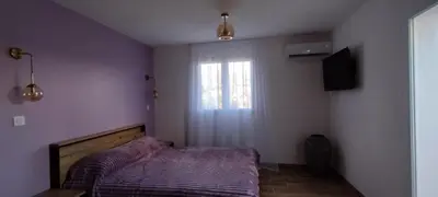 a small bedroom with a bed and a window at Villa Viktoriia in San-Nicolao