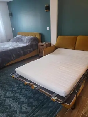 two beds in a room with a mattress on the floor at Villa Viktoriia in San-Nicolao