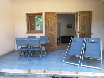 a group of blue chairs sitting on a patio at jolie location in Porto-Vecchio
