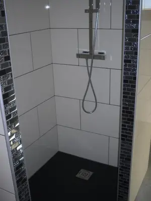 a bathroom with a shower with a shower head at jolie location in Porto-Vecchio