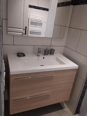 a bathroom with a sink and a mirror at jolie location in Porto-Vecchio