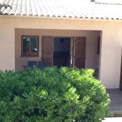 a house with green bushes in front of it at jolie location in Porto-Vecchio