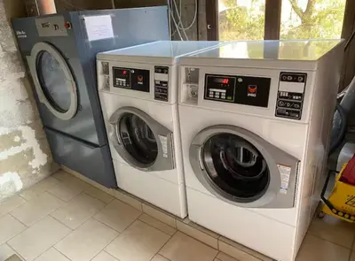 two washing machines sitting next to each other in a room at Terra Corsa Duplex T2 in Porto Ota