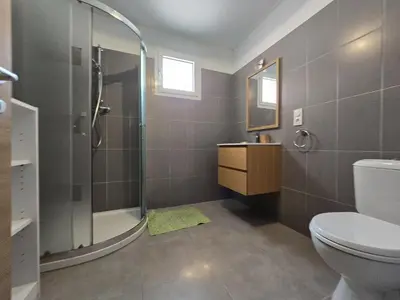 a bathroom with a shower and a toilet and a sink at Charmant studio avec extérieur in Corte