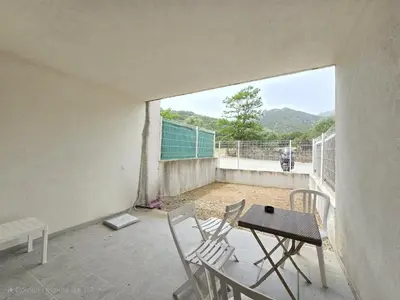 a balcony with chairs and a table and a view at Charmant studio avec extérieur in Corte