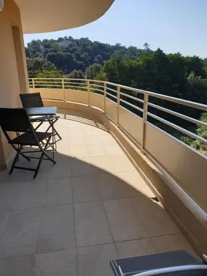 a balcony with chairs and a railing on a building at T3 Corté vue sur la Citadelle in Corte